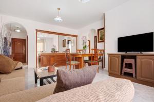 a living room with a television and a dining room at Casa Rosi in Gran Tarajal