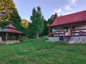 a house with a red roof and a gazebo at HENRYKOWO in Stronie Śląskie