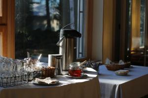 a table with a white table cloth with a drink mixer at Hotel Sofia in Helsinki