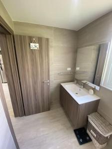ein Bad mit einem Waschbecken und einem Spiegel in der Unterkunft Estancia Mónaco, Hard Rock CANA BAY in Punta Cana