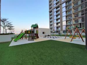 a park with a playground with a slide at Perfect 1 BR for Family Stay - Close to Downtown in Dubai