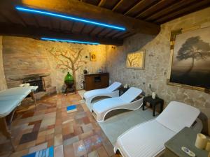 a room with three white beds and a fireplace at I SEI FILARI in Capannori