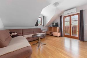 a living room with a couch and a table at Apartma Metka in Medvode