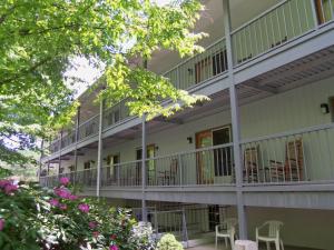 a building with tables and chairs on the balconies at Four Seasons Inn in Maggie Valley