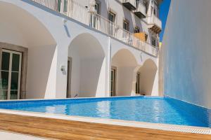 a swimming pool on the side of a building at Beach Waves Apartment in Faro