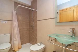 a bathroom with a toilet and a sink at Casa Nord 10Pax in Caimari +48 photos