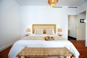 a bedroom with a bed with a basket of fruit on it at Algarve Sweetness Apartment in Faro +14 photos