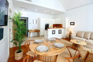 a dining room and living room with a table and chairs at Algarve Sweetness Apartment in Faro