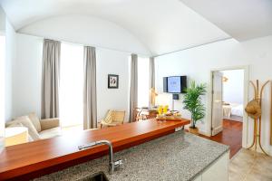 a living room with a kitchen with a counter top at Algarve Sweetness Apartment in Faro