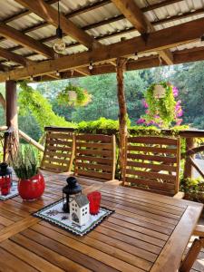 a wooden table with two chairs on a wooden deck at DOMEK NA GÓRACH z GORĄCĄ BALIĄ i SAUNĄ in Nowy Sącz