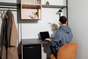 a woman sitting at a desk with a laptop at Bob W Oslo Sentralen in Oslo +41 photos