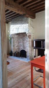 a living room with a large brick fireplace at De Zomere B&B in Bruges