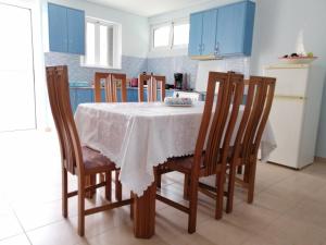 a kitchen with a table with chairs and blue cabinets at Mikes View in Astros