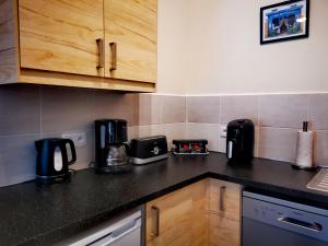 a kitchen with a black counter top with appliances at Quatre Saisons Été in Bergerac