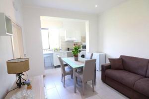 a living room with a couch and a table with chairs at Casa Ninà in Sant'Agnello