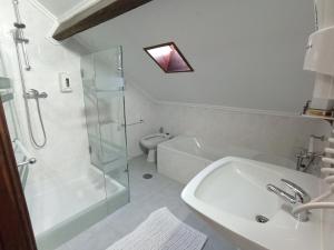 a bathroom with a shower and a sink and a toilet at 57 in Porto +37 photos