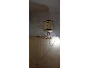 a light in a bathroom with a tile wall at Hotel Westend, Mussoorie in Mussoorie