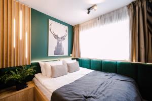 a bedroom with a bed with a deer picture on the wall at Moon Resort in Buşteni