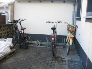 three bikes are parked next to a building at Diamanthaus deluxe 7 Koblenz in Koblenz