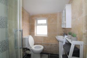 a bathroom with a toilet and a sink and a shower at Studio 2 min walk to Upton Park Station in London