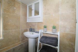 a bathroom with a sink and a mirror at Studio 2 min walk to Upton Park Station in London