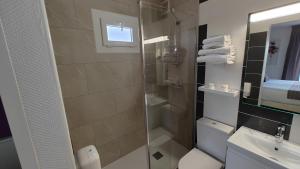 a bathroom with a shower and a sink at Logis Hôtel Les Bleuets in Royan +46 photos