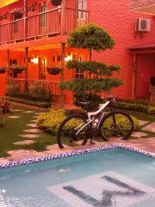 a bike parked next to a swimming pool in front of a building at FÁTIMA REAL in Ríohacha