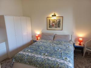1 dormitorio con 1 cama y 2 lámparas en 2 mesas en The Englishmans Home, en Cuglieri