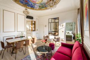 a living room with a red couch and a table at Luxury 3 Bedrooms 2 Bathrooms Apartment - Opera Louvre in Paris