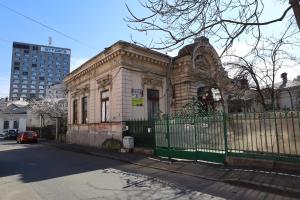 an old building with a fence in front of it at Center Haus in Bucharest