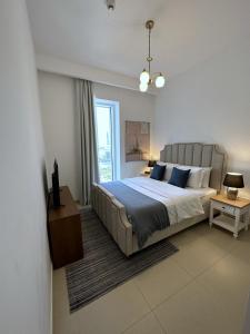 a bedroom with a large bed and a large window at Magnolia- Dubai Creek Harbour Condo Apartment ApartHotel UAE in Dubai