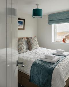 a bedroom with a bed with towels on it at May Isle View in Anstruther