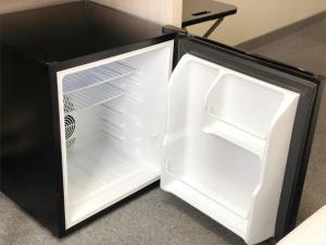 an empty refrigerator with its door open on the floor at Hotel Wing International Premium Osaka-Shinsekai in Osaka