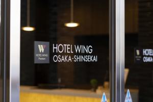 a window with a hotel wing sign on it at Hotel Wing International Premium Osaka-Shinsekai in Osaka