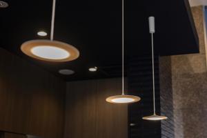 three lights hanging from the ceiling in a room at Hotel Wing International Premium Osaka-Shinsekai in Osaka