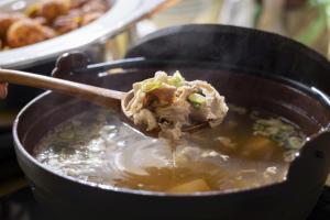 a spoonful of food in a pot of food at Hotel Wing International Premium Osaka-Shinsekai in Osaka