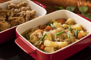 a red container of food with vegetables and meat at Hotel Wing International Premium Osaka-Shinsekai in Osaka