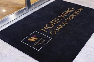 a black welcome mat with the words welcome center on it at Hotel Wing International Premium Osaka-Shinsekai in Osaka