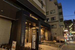 a store front with a sign in front of a building at Hotel Wing International Premium Osaka-Shinsekai in Osaka