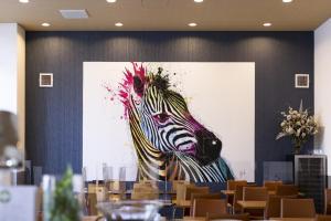 a painting of a zebra on a wall at Hotel Wing International Premium Osaka-Shinsekai in Osaka