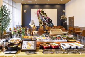 a buffet of food with a zebra on the wall at Hotel Wing International Premium Osaka-Shinsekai in Osaka