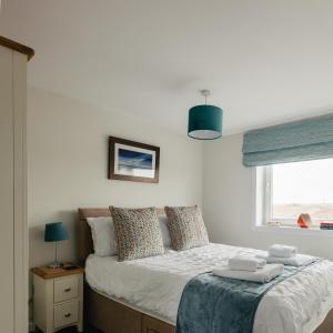 1 dormitorio con 1 cama con toallas en May Isle View, en Anstruther