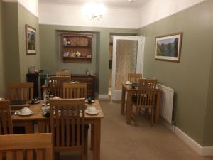 a dining room with wooden tables and chairs at Tarn Hows in Keswick