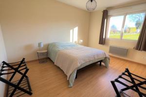 a bedroom with a bed and a large window at Maison avec véranda - Gîte de l'Arbrisseau in Rethel