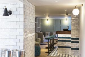 a room with a bar with stools in it at The Old Stocks Inn in Stow on the Wold