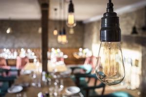 a light bulb hanging over a table in a restaurant at The Old Stocks Inn in Stow on the Wold