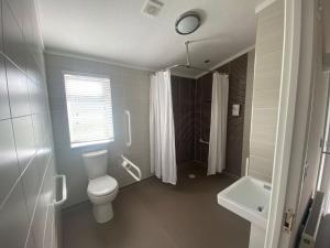 a bathroom with a toilet and a sink at Croyde Bay Hotel or Self Catering in Croyde
