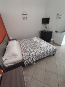 a bedroom with a bed with a black and white comforter at La dimora di Roberto in Santeramo in Colle