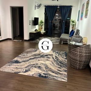 a living room with a rug on the floor at Galleria Homestay Vista Bangi in Kajang