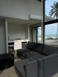 a living room with a couch and a view of the ocean at Meet Up Villa 